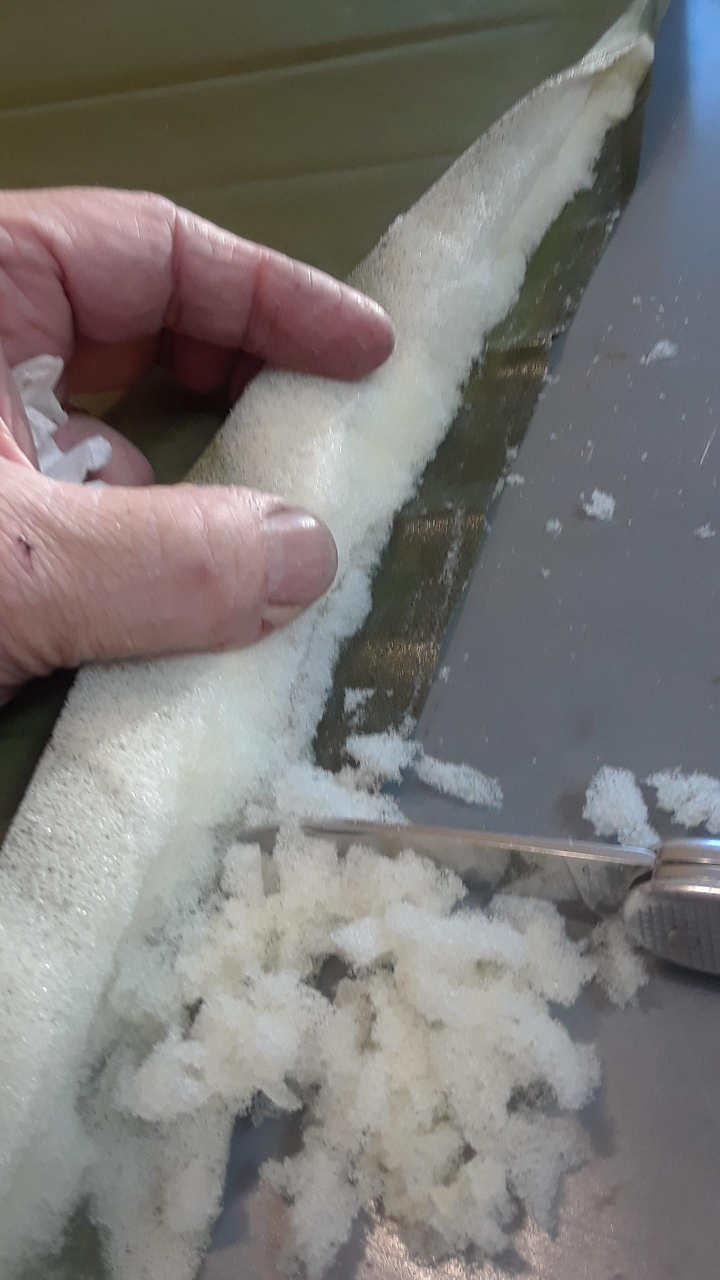 Cleaning the foam off the fabric to form the new seam